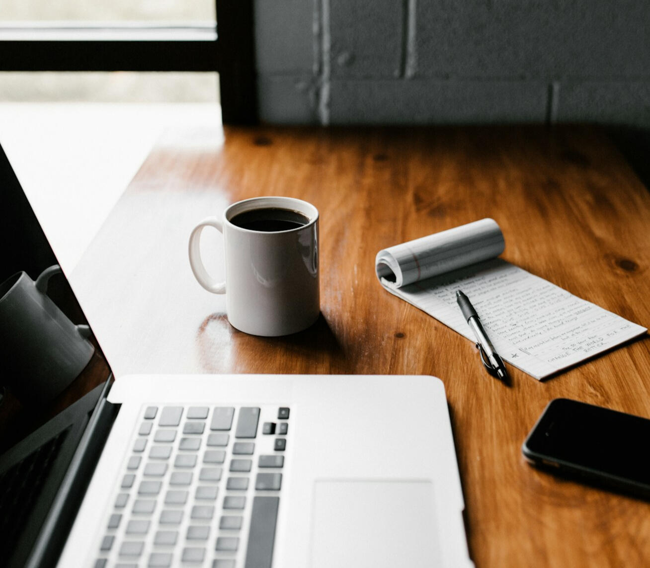 Research desk Photo of desk with computer, notepad, and coffee by Andrew Neel on Unsplash